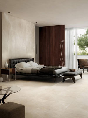Modern bedroom with a bed, nightstands, and a large window featuring a seamless look from large porcelain panels.